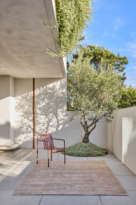 Location image of the Cove Linen outdoor rug by Designer Rugs, showing its handloom-knotted texture and subtle taupe tones that bring warmth and elegance to outdoor spaces.