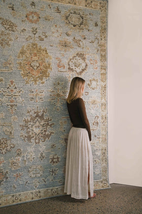 location image the Yok Blue rug from the Oushak Collection, featuring a soft blue, beige and terracotta traditional pattern