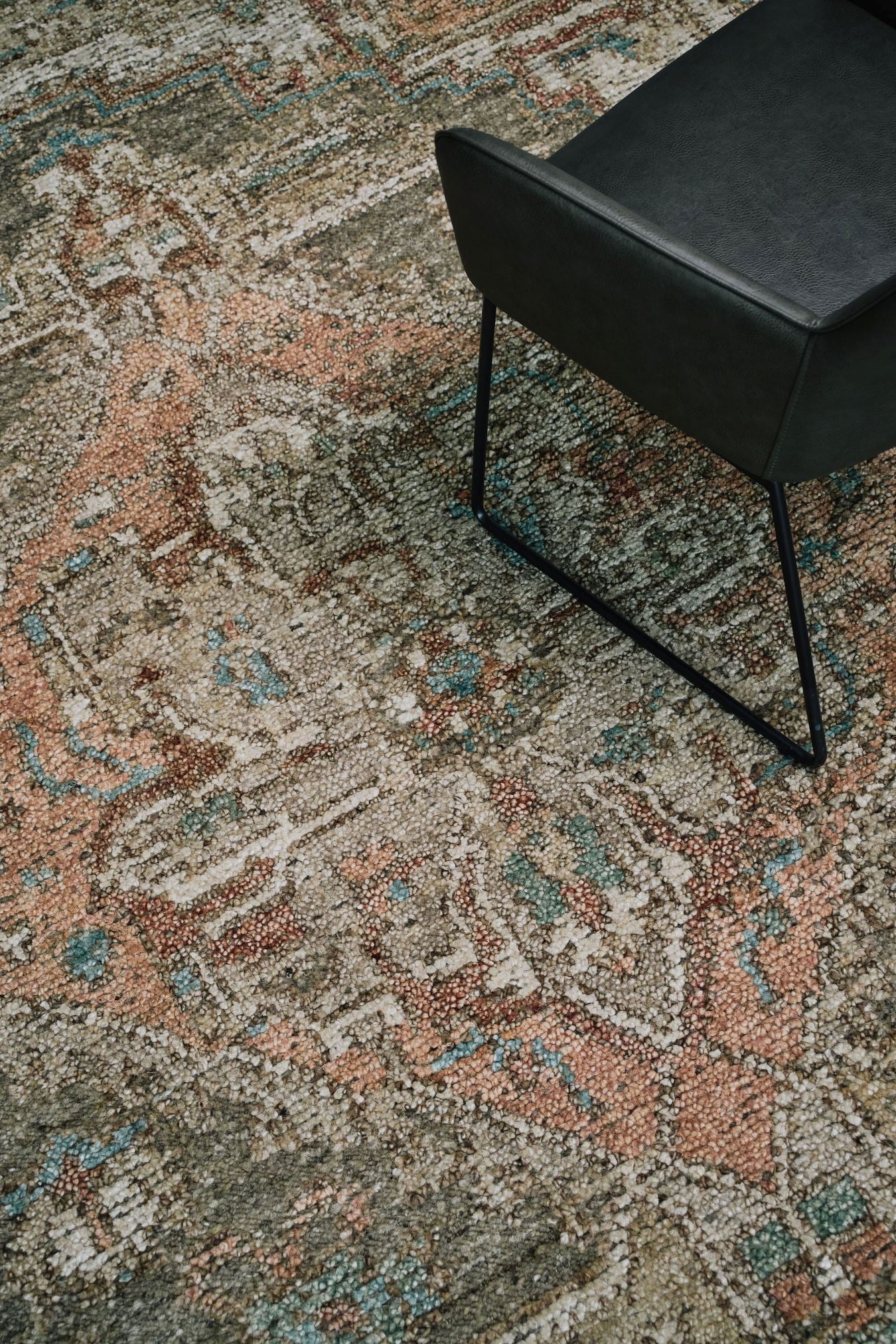 Close-up of the Zaman rug from the Oushak Collection, featuring a traditional pattern in olive, cream, terracotta and