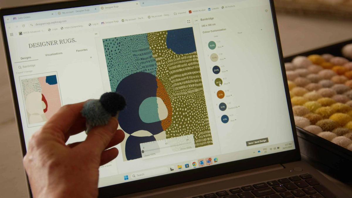A designer working on a rug design in the studio
