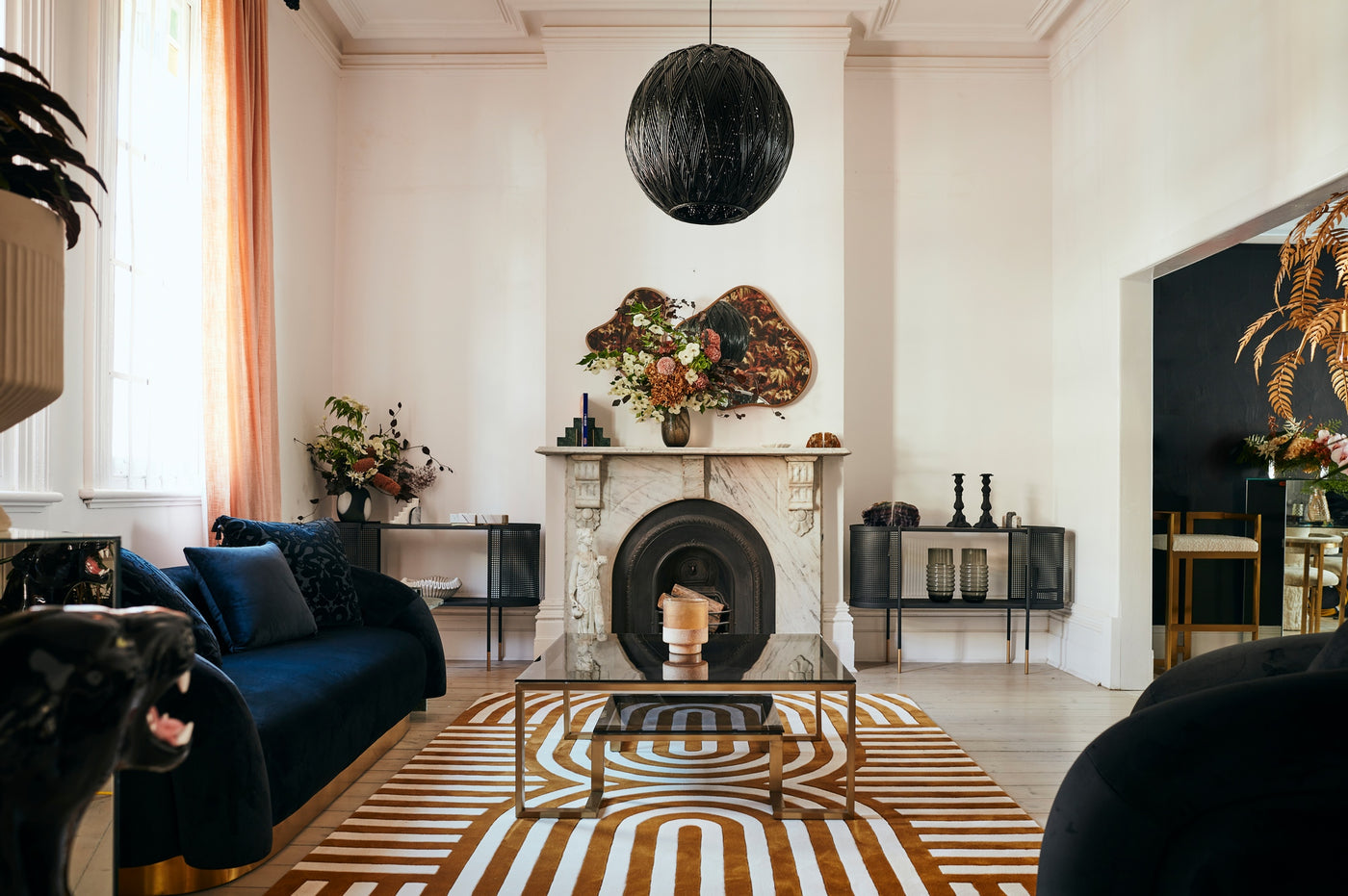 Living room view of modern, art deco Walter rug in mustard.