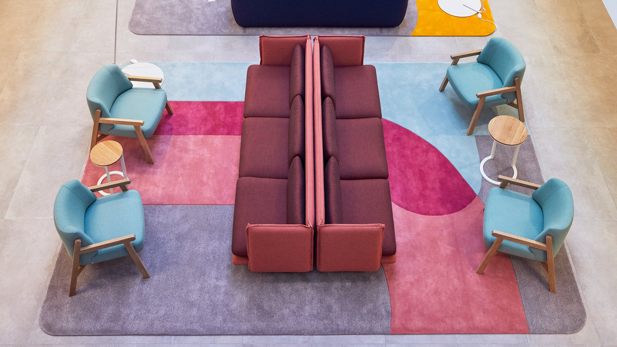 Custom rugs in colour beneath armchairs and side tables