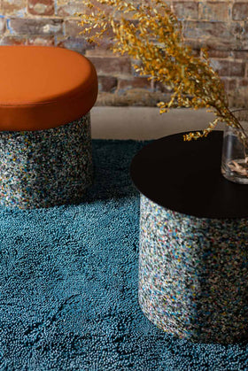 Styled close up view of textured Coral Shag rug in teal blue colour