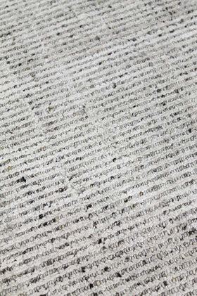 Detailed image of textured Gomez rug in light grey colour