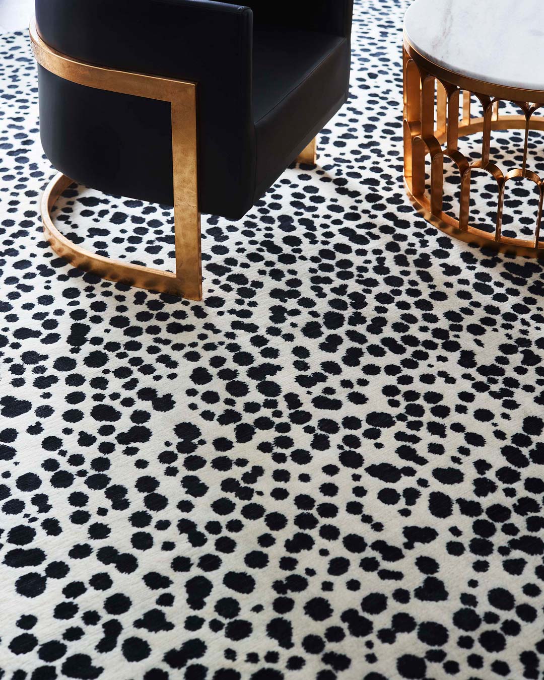 close up shot of dapple rug by greg natale black dots on white background