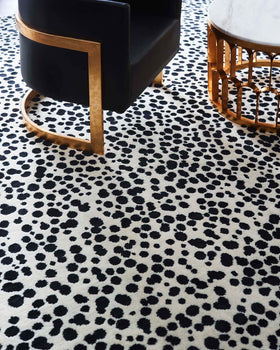 close up shot of dapple rug by greg natale black dots on white background