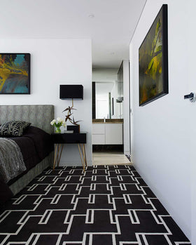 Bedroom view of Dianne black and white patterned Axminster carpet by Greg Natale