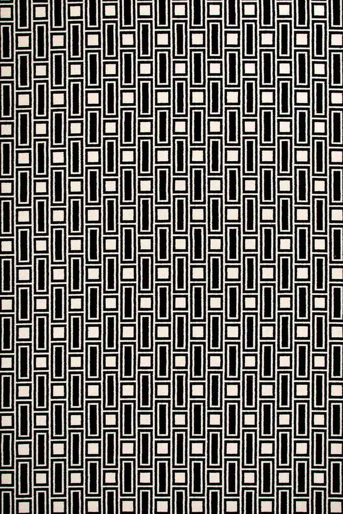 Overhead view of Tom black and white geometric Axminster carpet by Greg Natale
