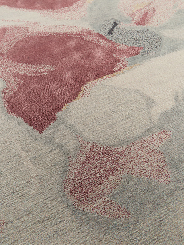 Close up image of organic petale handknot rug by Hare and Klein in pink, beige , charcoal and yellow