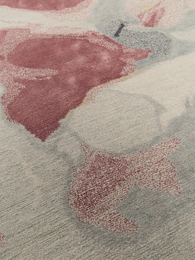 Close up image of organic petale handknot rug by Hare and Klein in pink, beige , charcoal and yellow