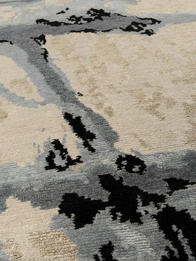 Close up image of organic Shores handknot rug by Hare and Klein in silver, charcoal and beige