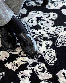 Close up image of Iona black and white floral Axminster carpet