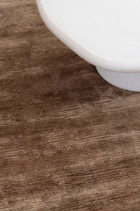 close up image of the rhodium-mahogany-texture rug