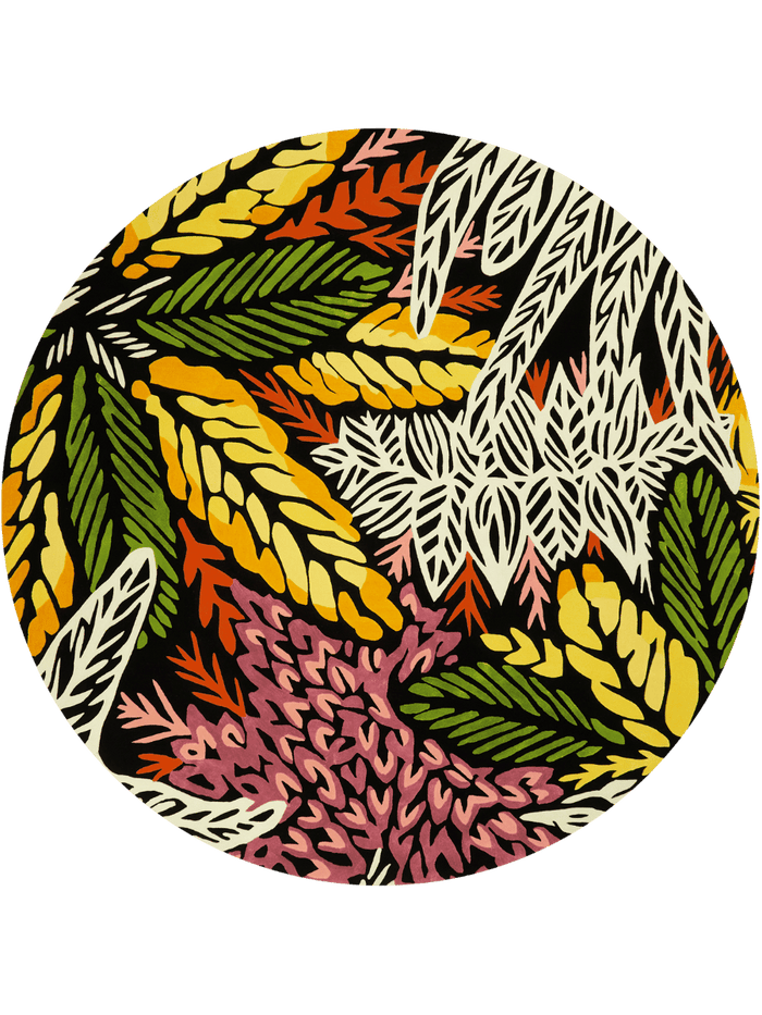 A circular graphic print featuring a dense, stylized botanical pattern with yellow, green, pink, orange, and white leaf-like motifs on a black background, set against a muted blue-gray backdrop.