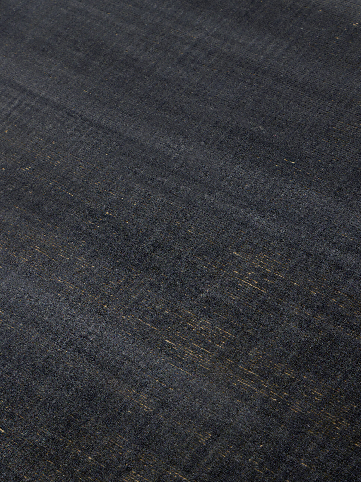 Close up image of the Ravira-charcoal-Honey rug