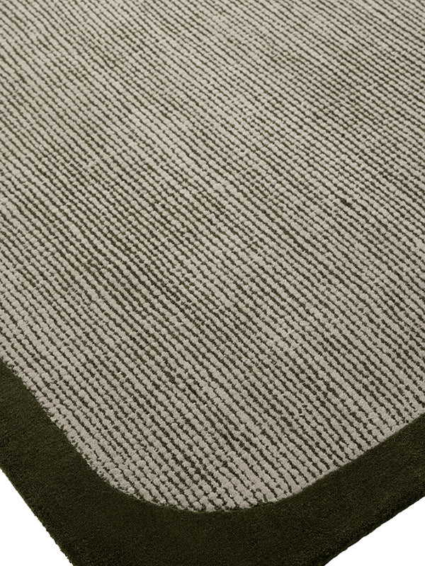 Close up image of the wolfram green-cement rug with border