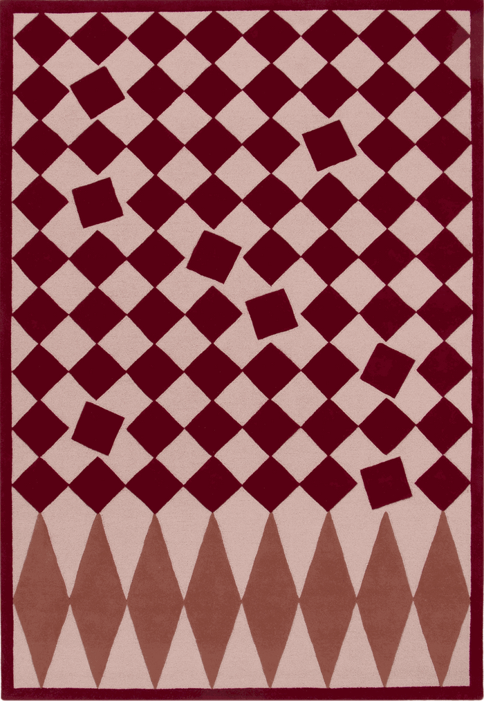 A rectangular area rug with a geometric harlequin pattern in deep burgundy and light beige, featuring diamond and square motifs.