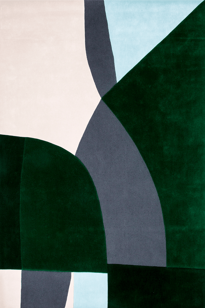 Abstract geometric rug featuring large blocks of deep forest green, slate gray, pale blue, and off-white with a subtle velvet texture.