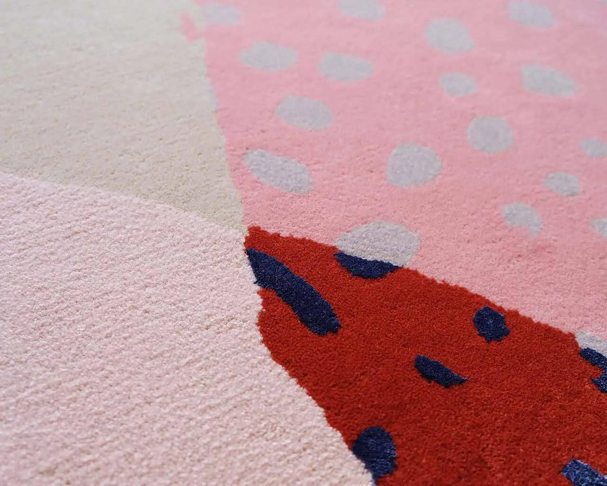 Hand tufted pile in blush with red and blue