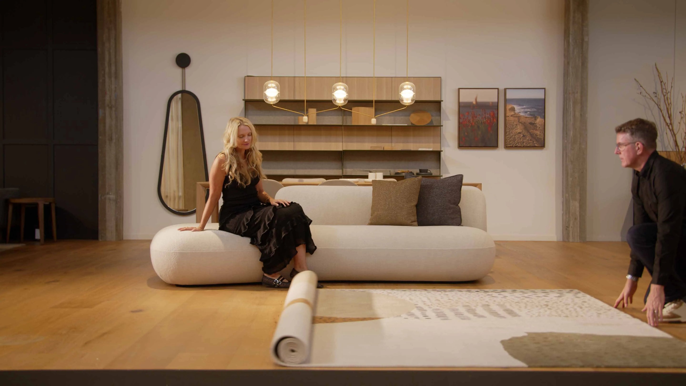 A rug being unrolled in a living room