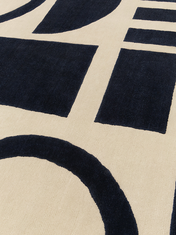 close up image of Forme rug in beige and Black